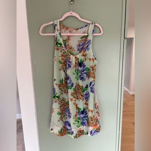 Sheer orange and purple floral mini dress with bright green slip.